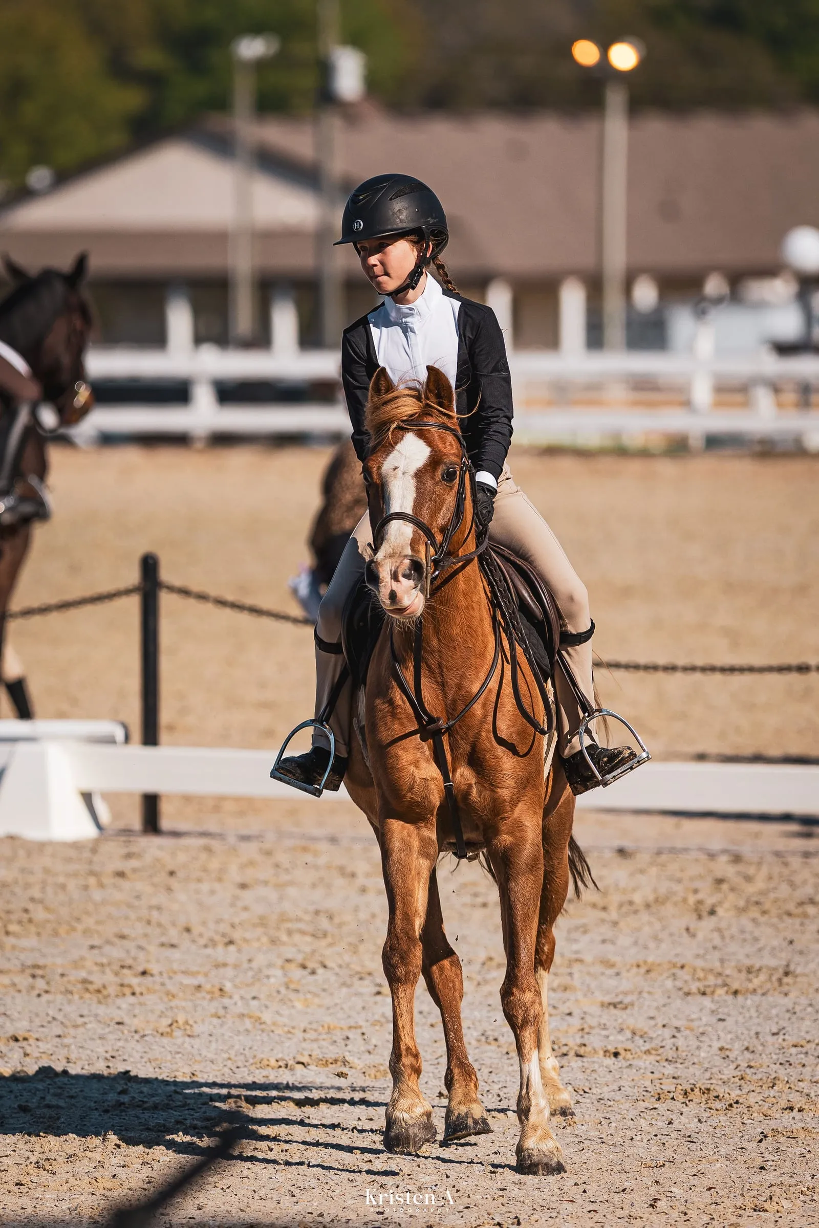 A chestnut pony and young rider walking into the show ring